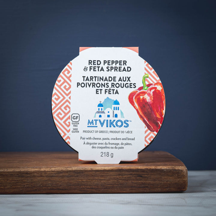 MT VIKOS red pepper and feta spread packaging on a wooden surface with a dark blue background