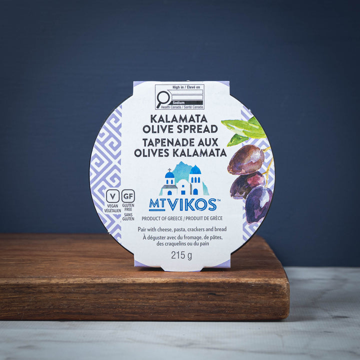 MT VIKOS Kalamata Olive Spread packaging on a wooden surface with a dark blue background