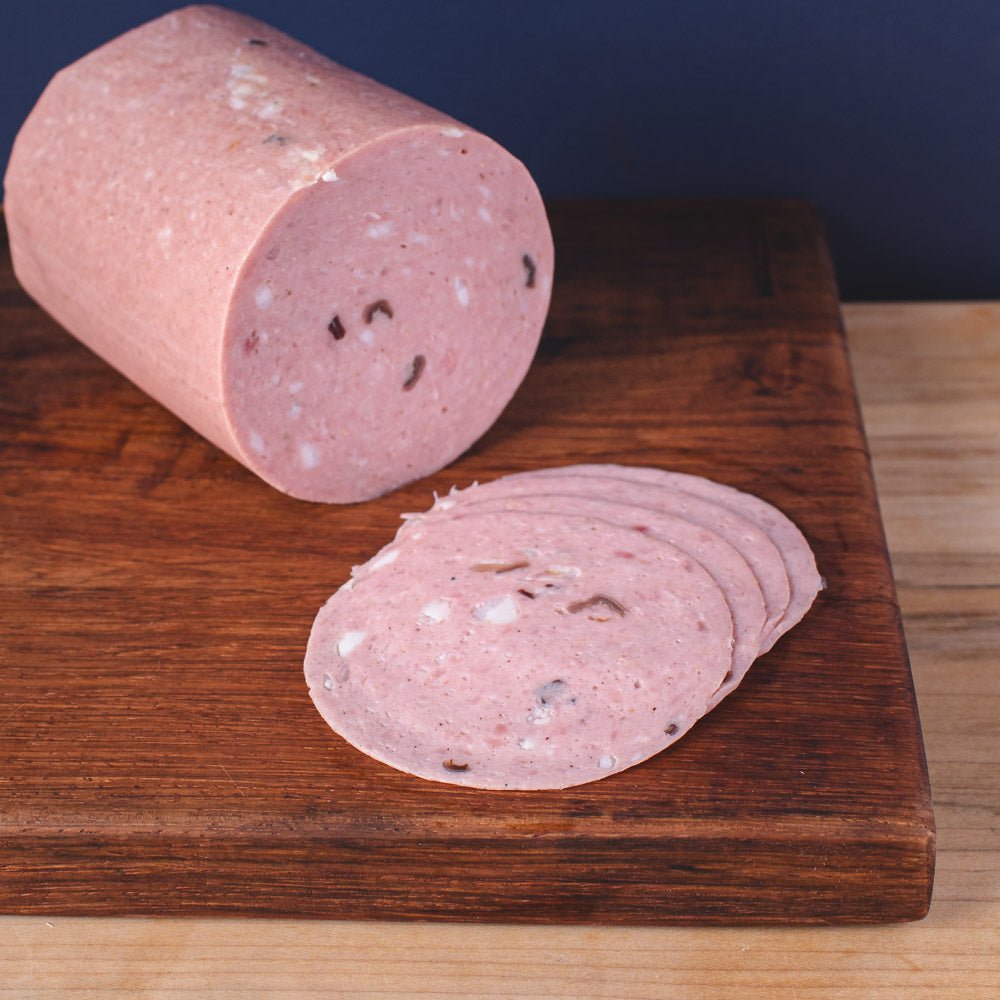 Black Truffle Mortadella - TOMME Cheese Shop. Delivering really good cheese across Ontario.